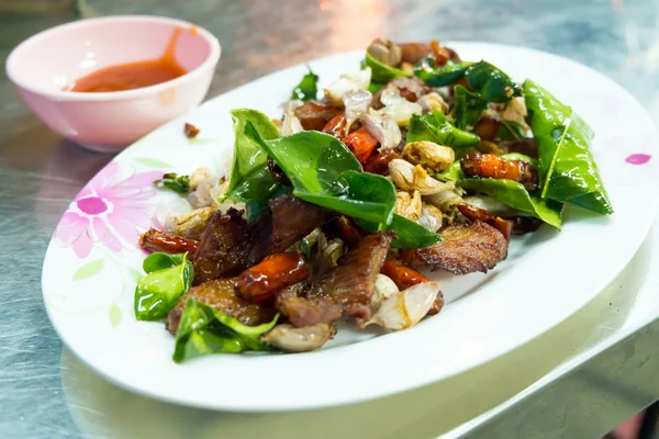 Delicious food in Northeast of Thailand made from deep fried pork, chili, garlic and basil — Stock Photo, Image