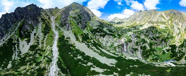 Panoramic view of Skok waterfall and the lake next to it in the western part of High Tatras, Slovakia