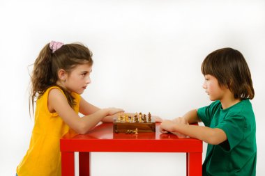 Beyaz arka plan üzerinde izole satranç oynayan çocuklar