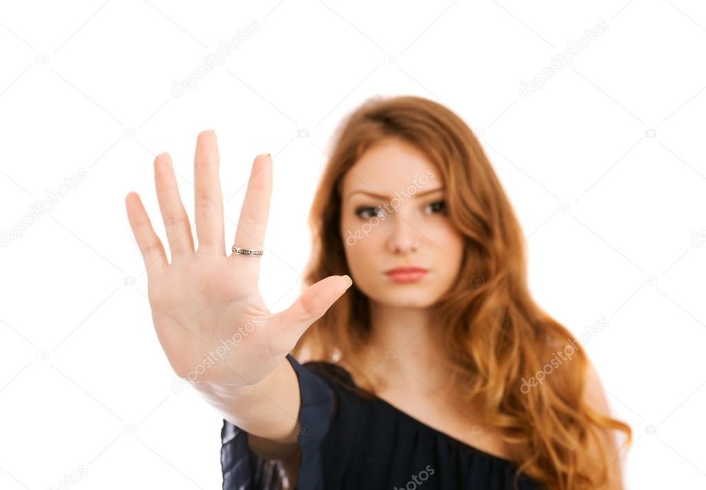 Young woman shows banning hand gesture isolated on white backgro