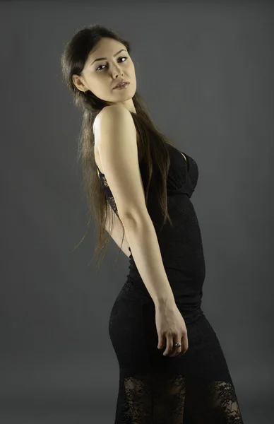 Portrait of beautiful brunette woman in black dress — Stock Photo, Image