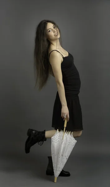 Portrait of beautiful brunette woman in black dress — Stock Photo, Image