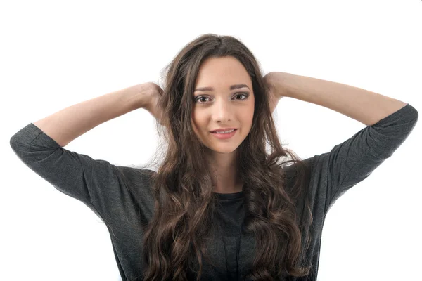 Beautiful young woman posing in studio on white background — Stock Photo, Image