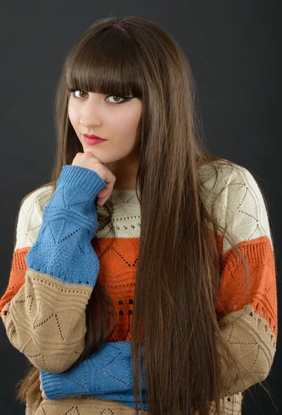 Portrait of a young beautiful woman with bangs in studio — Stock Photo, Image