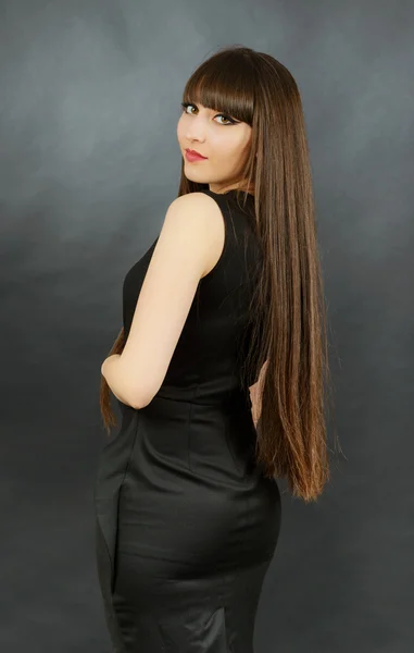 Portrait of a young beautiful woman with bangs in studio — Stock Photo, Image