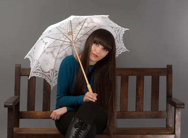 Portrait of a young beautiful woman with bangs in studio — Stock Photo, Image