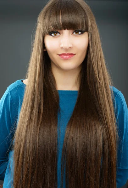 Portrait of a young beautiful woman with bangs in studio — Stock Photo, Image