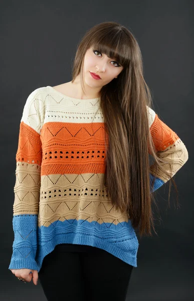 Portrait of a young beautiful woman with bangs in studio — Stock Photo, Image