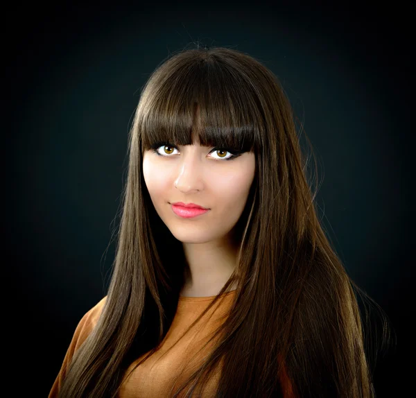 Portrait of a young beautiful woman with bangs in studio — Stock Photo, Image