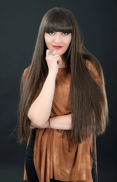 Studio portrait of attractive young woman with long hair — Stock Photo, Image