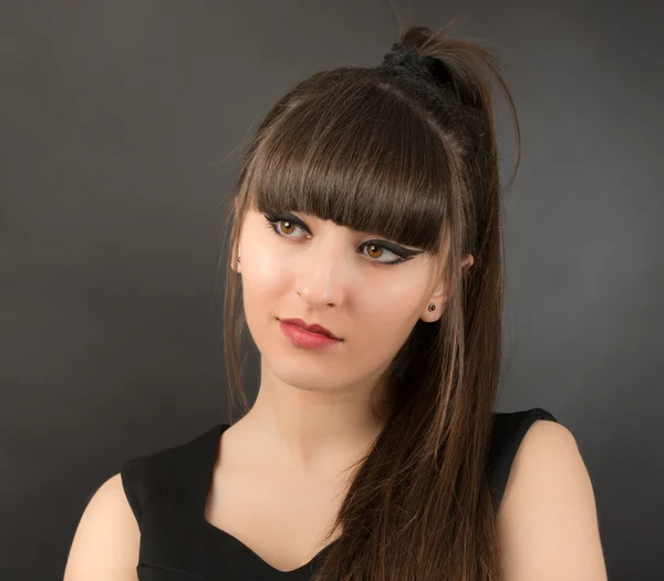 Studio portrait of attractive young woman with long hair — Stock Photo, Image