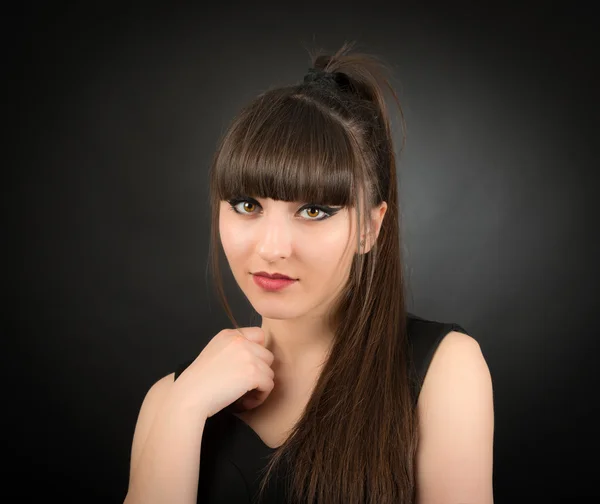 Studio portrait of attractive young woman with long hair — Stock Photo, Image