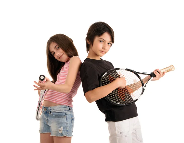 Two happy children posing with tennis racquets on white backgrou — Stock Photo, Image