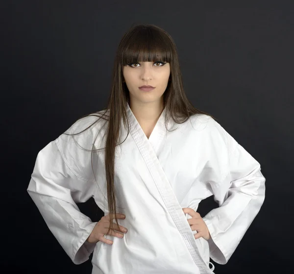 Karateka asian girl on black background studio shot — Stock Photo, Image