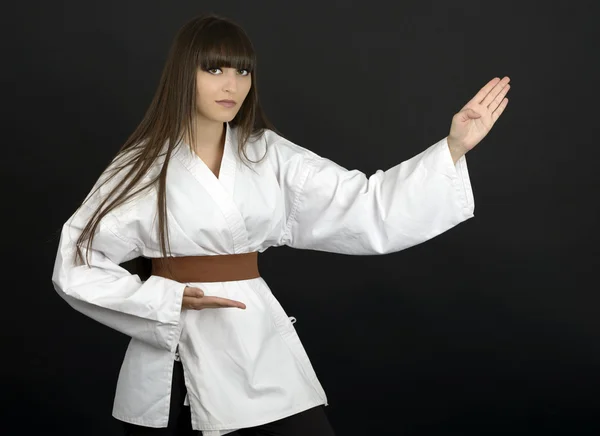 Karateka asian girl on black background studio shot — Stock Photo, Image