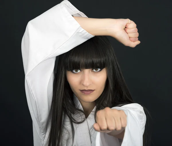 Karateka asian girl on black background studio shot — Stock Photo, Image