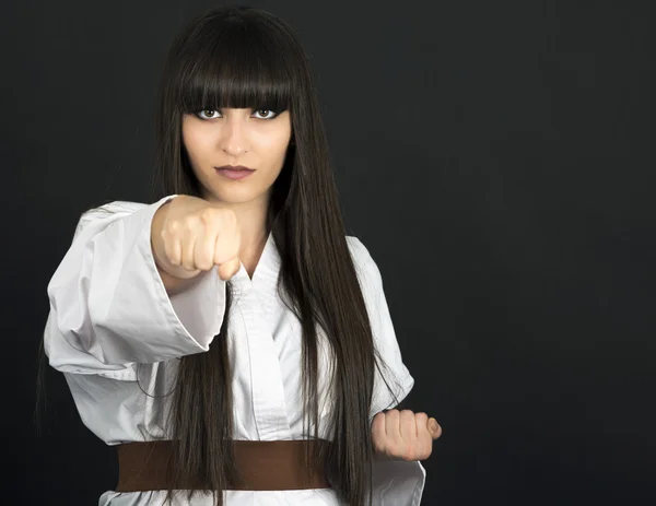 Karateka asian girl on black background studio shot — Stock Photo, Image