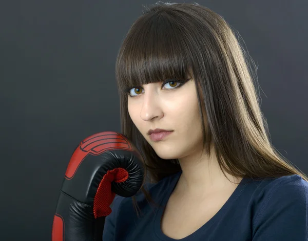 Young girl over black background with boxing gloves — Stock Photo, Image