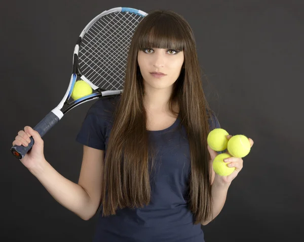 Female tennis player with racket and ball on black background — Stock Photo, Image