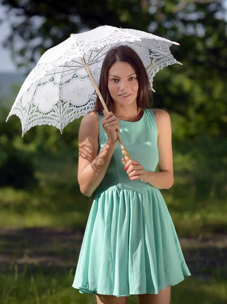 Young beautiful woman with umbrella in the park — Stock Photo, Image