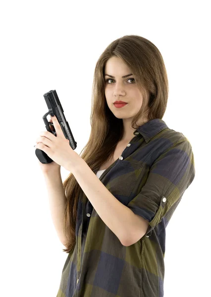 Young beautiful woman holding a gun on white background — Stock Photo, Image