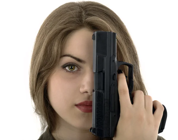 Young beautiful woman holding a gun on white background — Stock Photo, Image