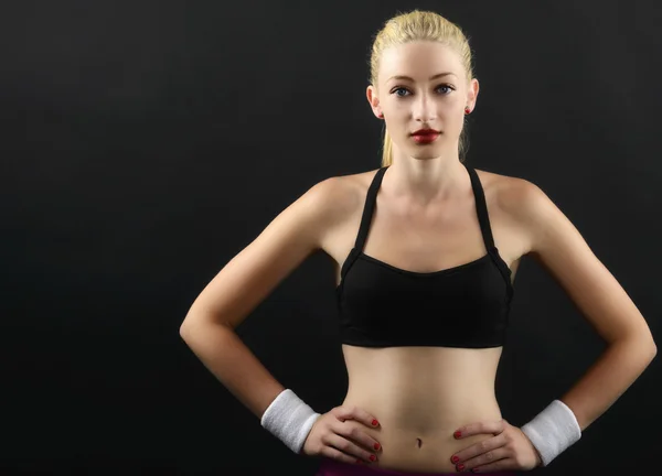 Portrait of a sexy fitness woman isolated on black — Stock Photo, Image