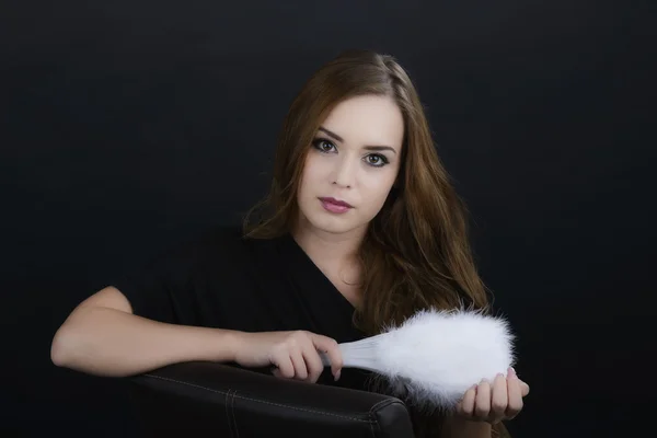 Young beautiful sexy blonde sitting in the dark with fan — Stock Photo, Image