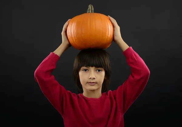 Portrait of little boy wearing halloween costume with pumpkin on — Stock Photo, Image