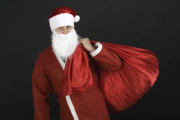 Santa Claus con saco de Navidad aislado sobre fondo negro — Foto de Stock