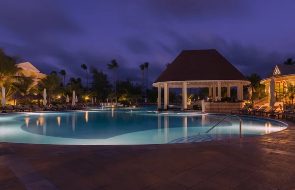 A pretty swimming pool in night at a local resort