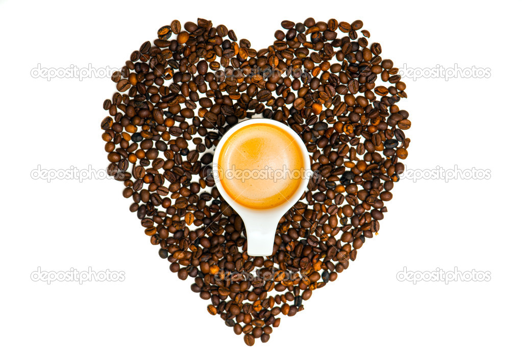 Heart from coffee beans with a cup in the middle