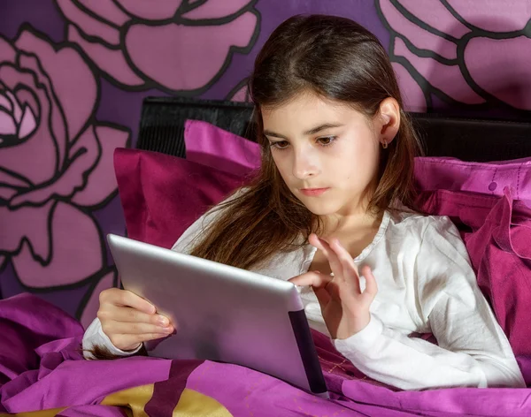 Girl with a tablet in the bedroom click — Stock Photo, Image