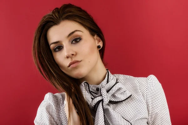 Portrait of a female fashion model posing against red background — Stock Photo, Image