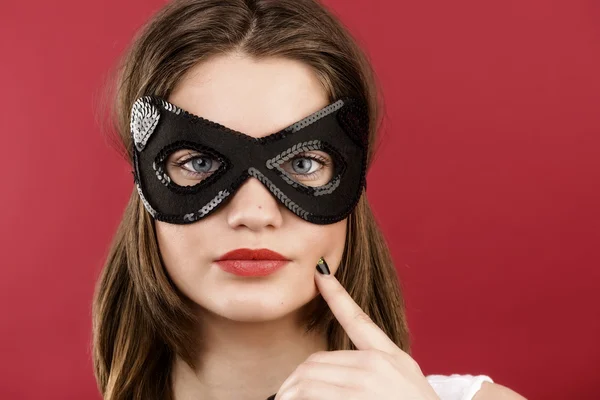 Pretty young girl in the decorative mask — Stock Photo, Image