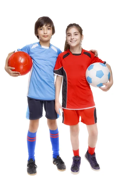 Pareja de niña y niño vestido con equipo de fútbol — Foto de Stock