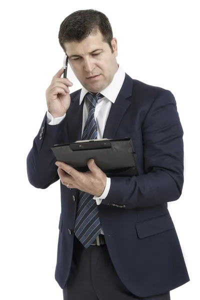 Человек с буфером обмена, говорящий по телефону — стоковое фото