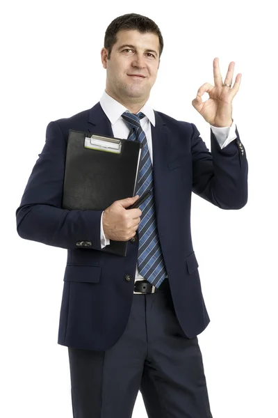 Businessman with a clipboard saying Ok isolated on white backgro — Stock Photo, Image
