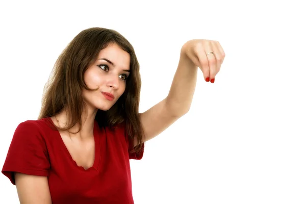 Young smiling woman points a hand with positive facial expressio Stock Image