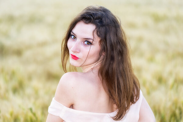 beautiful woman posing in wheat field