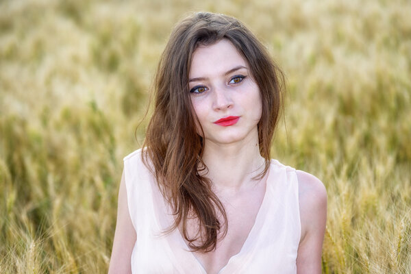 beautiful woman posing in wheat field