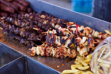 Metal şişte pişen ızgara kebap. Barbeküde pişmiş et. Barbekü taze et dilimleri. Geleneksel doğu yemeği, şiş kebap. Kömür ve alevler üzerine ızgara, piknik, sokak yemekleri