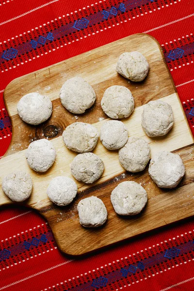 meatballs ready to be cooked on a wood chipper