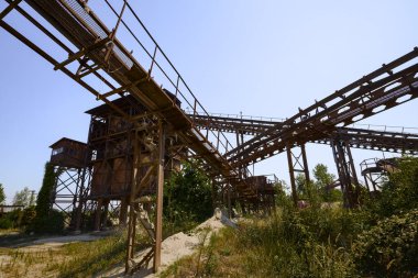 Abandoned factory, Gravel mining and production. Belt mechanism. Extruder.