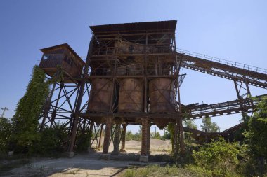 Abandoned factory, Gravel mining and production. Belt mechanism. Extruder.