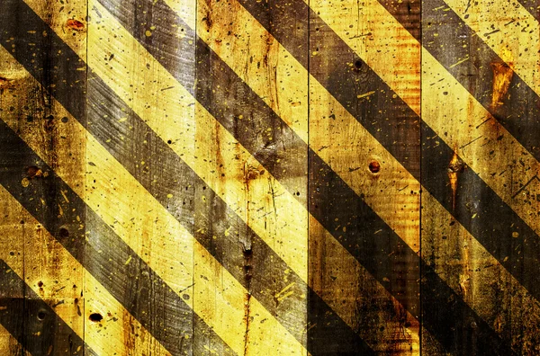 Under construction strips on wooden background — Stock Photo, Image