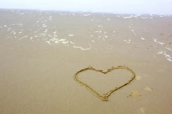 Heart shape drawn on beach Royalty Free Stock Photos