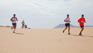 CORRALEJO - NOVEMBER 03: Participants running in the dunes at Fo clipart