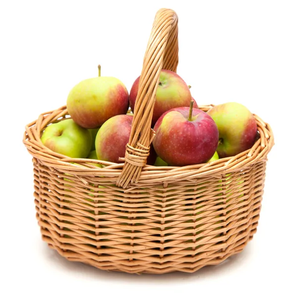 Wicker basket full of apples — Stock Photo, Image