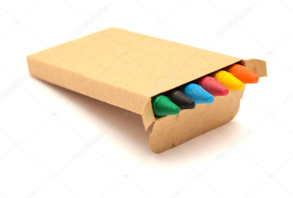 small box of color wax crayons, isolated on white background